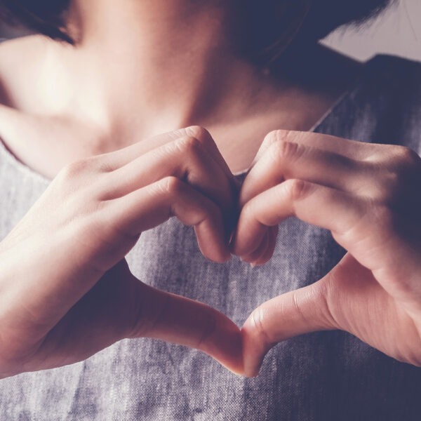 Woman Making Heart Symbol With Hands